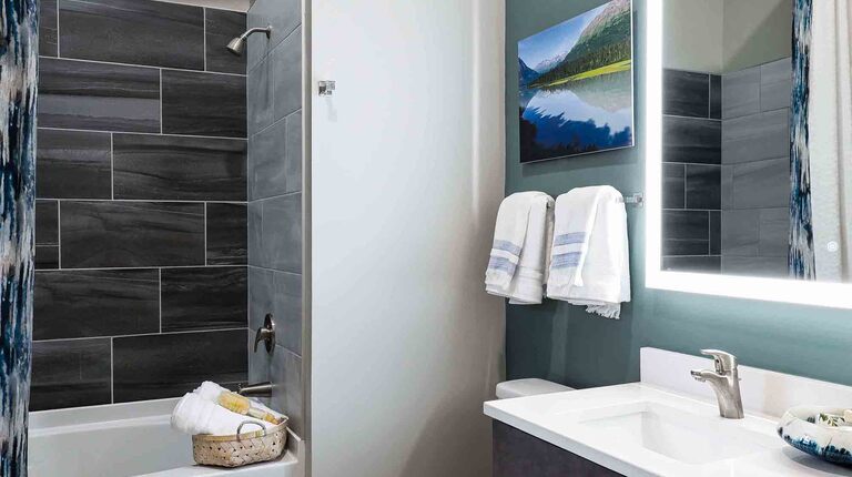 Spacious Bathroom with Custom Vanity and LED Mirror